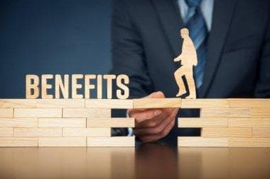 Benefits wooden blocks with a figure climbing toward growth